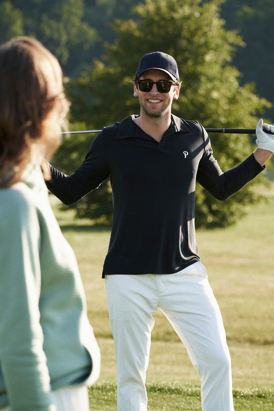 male golfer wearing Palmar's longsleeve polo in black