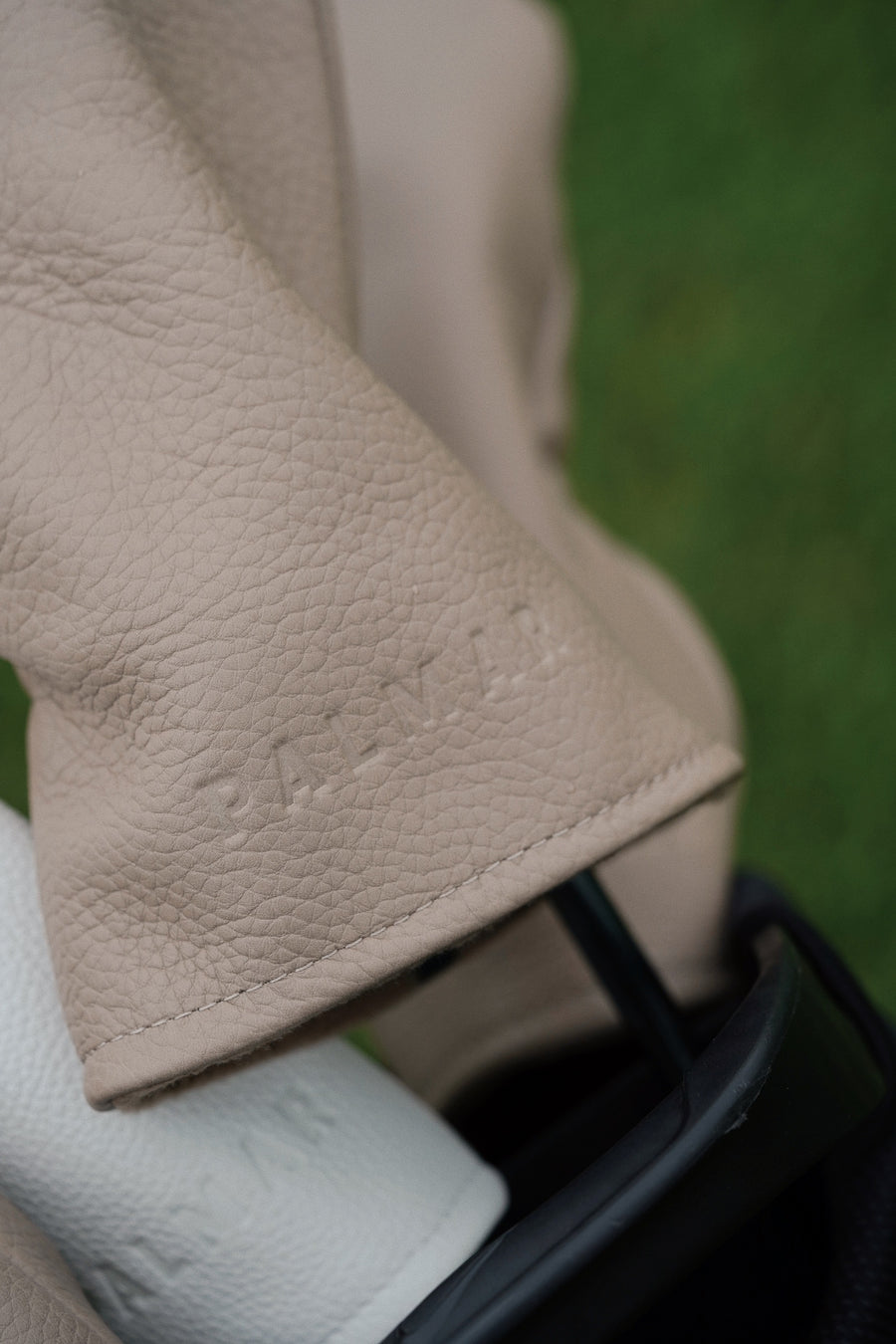 beige leather headcovers with embossed palmar logo